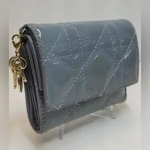 Christian Dior enamel cannage lady Dior mini bifold wallet with Dior charms.