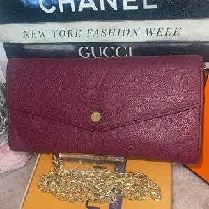 Louis Vuitton Empreinte Curieuse envelope style wallet on a chain.